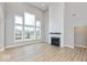 Spacious living room featuring a fireplace with a white shiplap surround and large windows at 1098 Gatewick Ct, Greenwood, IN 46143