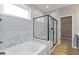 Luxurious Primary bathroom boasting marble tile, a glass-enclosed shower, and a soaking tub at 1098 Gatewick Ct, Greenwood, IN 46143