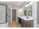 Modern bathroom featuring a double vanity, walk-in shower, and a separate soaking tub at 1098 Gatewick Ct, Greenwood, IN 46143