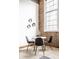 Small dining area with round table and four chairs near a brick wall at 735 Lexington Ave # Apt 8, Indianapolis, IN 46203