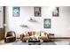Bright living room with leather couch, coffee table, and travel posters at 735 Lexington Ave # Apt 8, Indianapolis, IN 46203