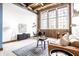 Spacious living area with exposed brick, large windows, and comfortable seating at 735 Lexington Ave # Apt 8, Indianapolis, IN 46203