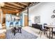 Open concept living space with exposed beams and a modern kitchen at 735 Lexington Ave # Apt 8, Indianapolis, IN 46203
