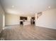 Open floor plan with kitchen island, stainless steel appliances, and luxury vinyl plank flooring at 91 Booth St, Whiteland, IN 46184