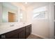 Double vanity bathroom with dark brown cabinets and a window at 91 Booth St, Whiteland, IN 46184