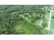 Aerial view of property showing house, barn, and cemetery amongst green trees and fields at 4463 W 700 S, Trafalgar, IN 46181