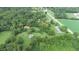Aerial view of property showing house, barn, and cemetery amongst green trees and fields at 4463 W 700 S, Trafalgar, IN 46181