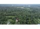 Aerial view of property showcasing surrounding landscape, trees, and a nearby lake at 4463 W 700 S, Trafalgar, IN 46181