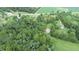 Aerial view of property showing house, barn, and cemetery amongst green trees and fields at 4463 W 700 S, Trafalgar, IN 46181