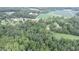 Aerial view of property showing house, barn, and cemetery amongst green trees and fields at 4463 W 700 S, Trafalgar, IN 46181