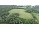 Aerial view of property with a large field bordered by trees, near a lake at 4463 W 700 S, Trafalgar, IN 46181