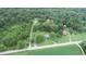 Aerial view of a house on a spacious lot with a circular driveway, surrounded by trees and farmland at 4463 W 700 S, Trafalgar, IN 46181