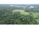 Aerial view of property highlighting a large open field and surrounding trees at 4463 W 700 S, Trafalgar, IN 46181