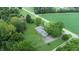 Aerial view of a ranch house with a spacious backyard, surrounded by trees and a paved driveway at 4463 W 700 S, Trafalgar, IN 46181