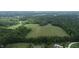 Aerial view of property, showcasing a large field surrounded by trees and homes at 4463 W 700 S, Trafalgar, IN 46181