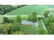 An aerial view of a ranch home with a large backyard, situated on a quiet country road at 4463 W 700 S, Trafalgar, IN 46181