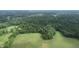 Aerial view of property, showcasing a large field surrounded by trees and homes at 4463 W 700 S, Trafalgar, IN 46181