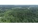 Aerial view showcasing property's wooded surroundings and nearby homes at 4463 W 700 S, Trafalgar, IN 46181