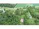 Aerial view of property showing house, barn, and cemetery amongst green trees and fields at 4463 W 700 S, Trafalgar, IN 46181