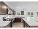 Modern kitchen with dark brown cabinets, stainless steel appliances, and an island at 3929 Highcrest Rd, Indianapolis, IN 46239