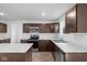 Modern kitchen with dark brown cabinets, stainless steel appliances, and an island at 3929 Highcrest Rd, Indianapolis, IN 46239