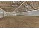 Spacious indoor riding arena with wooden beams and large doors at 7601 S 700 W, Morgantown, IN 46160