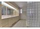 Bathroom with granite countertop, double sinks, and glass block shower at 7601 S 700 W, Morgantown, IN 46160