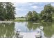 Serene pond with a dock and benches, offering a peaceful waterfront view at 7601 S 700 W, Morgantown, IN 46160