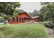 Red house exterior with deck and surrounding trees at 7601 S 700 W, Morgantown, IN 46160
