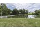 Serene pond with lush greenery and birdhouses at 7601 S 700 W, Morgantown, IN 46160