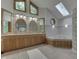 Elegant bathroom with a large soaking tub, double vanity, and skylight at 7601 S 700 W, Morgantown, IN 46160
