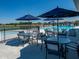 Relaxing pool area with tables and umbrellas for shade at 6301 Rhinecliff Dr, Whitestown, IN 46075