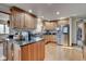 Island kitchen with granite countertops and stainless steel appliances at 303 Wellington Overlook, Noblesville, IN 46060