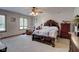 Comfortable bedroom with a queen-size bed and sitting area at 303 Wellington Overlook, Noblesville, IN 46060