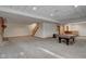 Finished basement featuring a pool table and brick fireplace at 303 Wellington Overlook, Noblesville, IN 46060