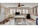 Sunroom with multiple windows, ceiling fan, and tile flooring at 303 Wellington Overlook, Noblesville, IN 46060