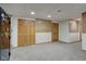 Finished basement with a large safe and built-in shelving at 303 Wellington Overlook, Noblesville, IN 46060