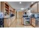 Kitchen features wood cabinets, granite countertops, and stainless steel appliances at 303 Wellington Overlook, Noblesville, IN 46060