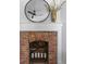 Rustic brick fireplace with white mantel and gold vase decor at 1046 Dawson St, Indianapolis, IN 46203