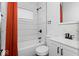 Modern bathroom with white subway tile, black fixtures, and orange shower curtain at 1046 Dawson St, Indianapolis, IN 46203