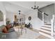 Open living room with gray sofa, glass coffee table, and view of kitchen and stairs at 1046 Dawson St, Indianapolis, IN 46203