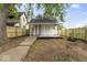 House with backyard, wooden fence, and small porch at 1046 Dawson St, Indianapolis, IN 46203