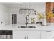 Kitchen features white cabinets, stainless steel appliances and a stylish light fixture at 1046 Dawson St, Indianapolis, IN 46203