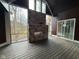 Spacious screened porch with a stone fireplace and wood-look deck flooring at 3380 N Pine Song Dr, Martinsville, IN 46151