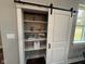 White pantry with sliding barn door at 3380 N Pine Song Dr, Martinsville, IN 46151
