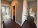 Bright hallway with dark tile flooring and access to bedrooms and a bathroom at 3380 N Pine Song Dr, Martinsville, IN 46151
