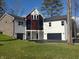 Modern farmhouse style home with white siding, black garage doors and a large yard at 3380 N Pine Song Dr, Martinsville, IN 46151