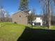 Modern home with gray brick exterior, attached garage and a large backyard at 3380 N Pine Song Dr, Martinsville, IN 46151