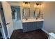 Modern bathroom with double vanity, large mirror, and dark tile flooring at 3380 N Pine Song Dr, Martinsville, IN 46151