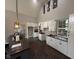 Modern kitchen with white cabinets, dark tile floors, and an island at 3380 N Pine Song Dr, Martinsville, IN 46151